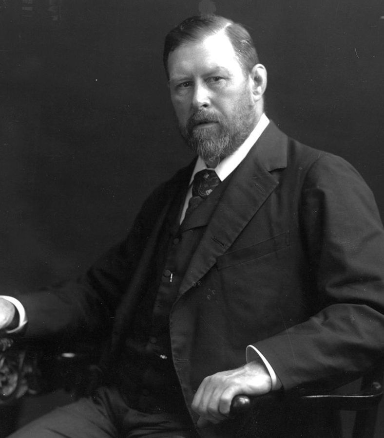 Photo of Bram Stocker sitting in a chair, unsmiling looking directly into the camera