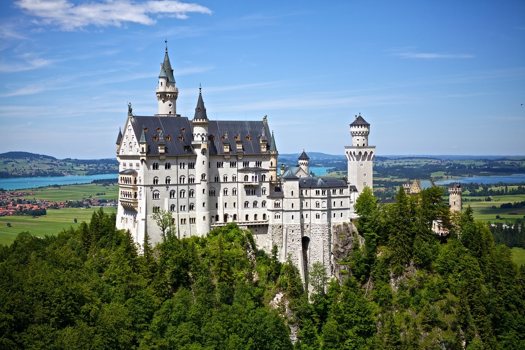 Photo of Bavarian castle set atop a lush hillside