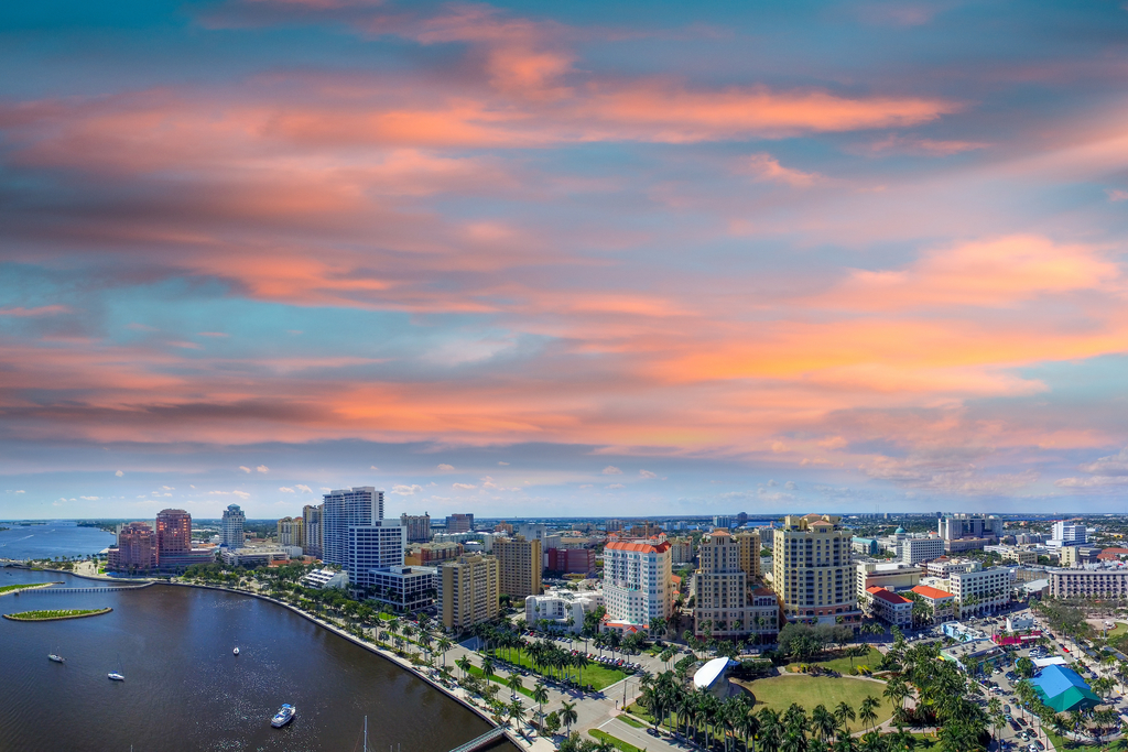 Aerial shot of West Palm skyline with the sunsetting in the background